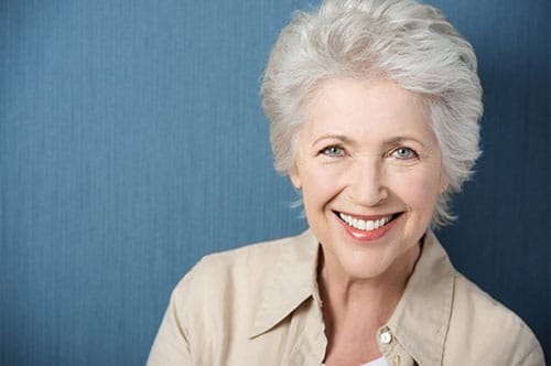 older woman wearing cost effective modern dentures
