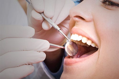 Young Female Patient Receiving a Dental Cleaning for Healthy Gums