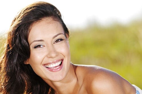 Caucasian Woman with Long Brunette Hair and Brown Eyes Smiling at the Camera
