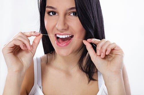 Woman Going Over Why Flossing Is Important